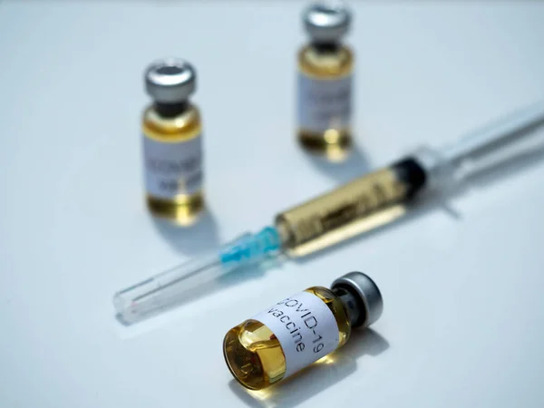 사진의 삽화에서 코로나 바이러스 백신이라고 이름붙여진 병들과 세계가 코로나 바이러스에 — 스톡 사진