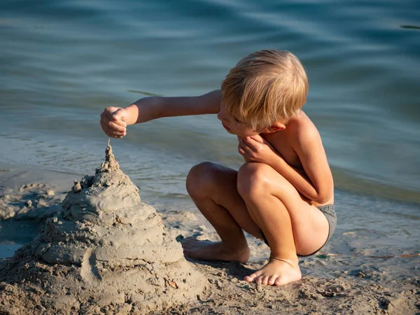 Vit Förskola Pojke Bygger Ett Slott Sand Stranden Sjön — Stockfoto