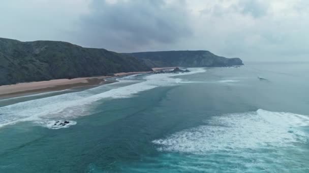 Flying over sandy beach and rocks in Portugal — Stock Video