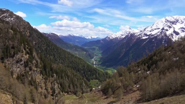 スイスの道路や村と高い雪で覆われた山々や谷の美しいトップビュー 傾斜ビュー4K — ストック動画