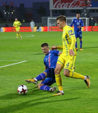 Reykjavik, İzlanda - 5 Eylül 2017: Johann Gudmundsson İzlanda (L) kavgalar bir top Mykola Matviyenko onların FIFA Dünya Kupası 2018 oyun Reykjavik, İzlanda eleme sırasında Ukrayna ile