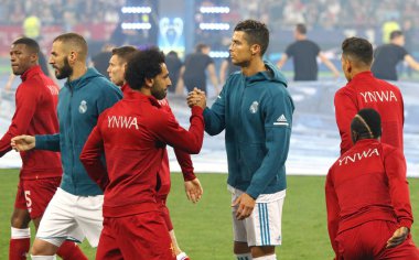 KYIV, UKRAINE - MAY 26, 2018: Mohamed Salah of Liverpool (L) cheers Cristiano Ronaldo of Real Madrid before their UEFA Champions League Final 2018 game at NSC Olimpiyskiy Stadium. Real Madrid won 3-1 clipart