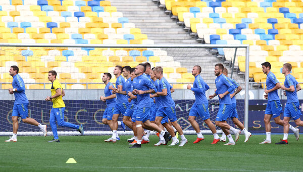 KYIV, UKRAINE - SEPTEMBER 4, 2018: Players run during Open training session of Ukraine National Football Team at NSC Olimpiyskyi stadium in Kyiv, Ukraine