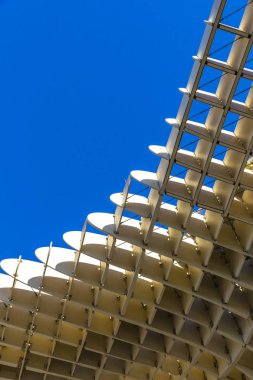 The Metropol Parasol (officially called Setas de Sevilla) is a structure in the shape of a pergola made of wood and concrete located at La Encarnacion square in the old quarter of Seville, Spain clipart