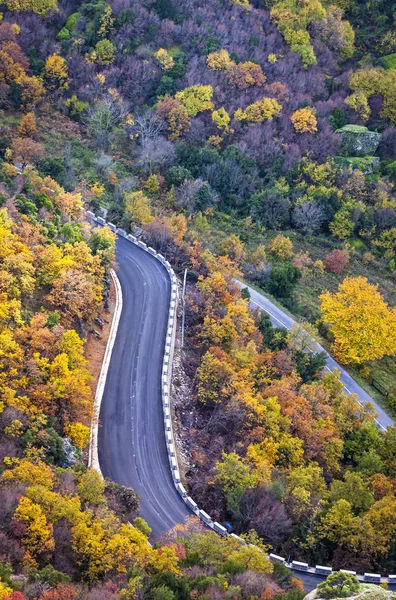 Picturesque mountain curved road in autumn. View from above. Meteora Rocks, Greece