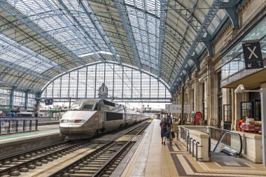 BORDEAUX, FRANCE - JUNE 13, 2017: High-speed train (TGV) arrives at platform of main railway station (Gare SNCF) of Bordeaux city, Bordeaux-Saint-Jean clipart