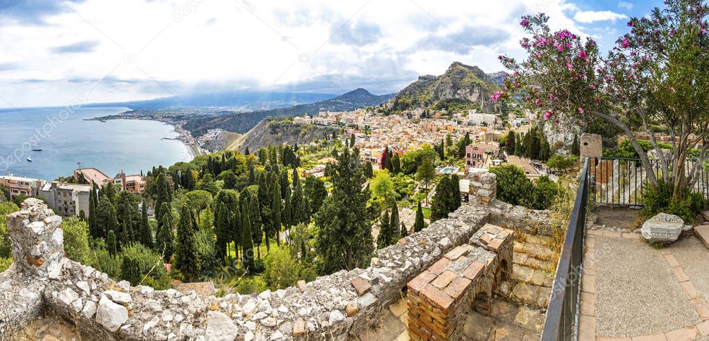 Panoramic view of Ionian seacoast and Taormina town, Sicily, Ita