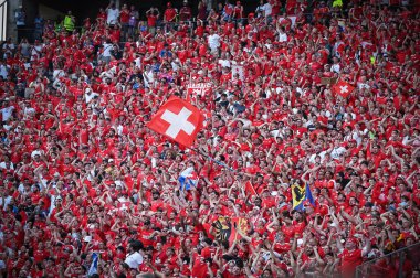Berlin, Germany - June 29, 2024: Swiss supporters show their support on tribunes of Olympiastadion in Berlin during the UEFA EURO 2024 Round of 16 game Switzerland v Italy