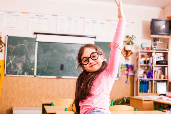 Happy smart girl in classroom — Stock Photo, Image