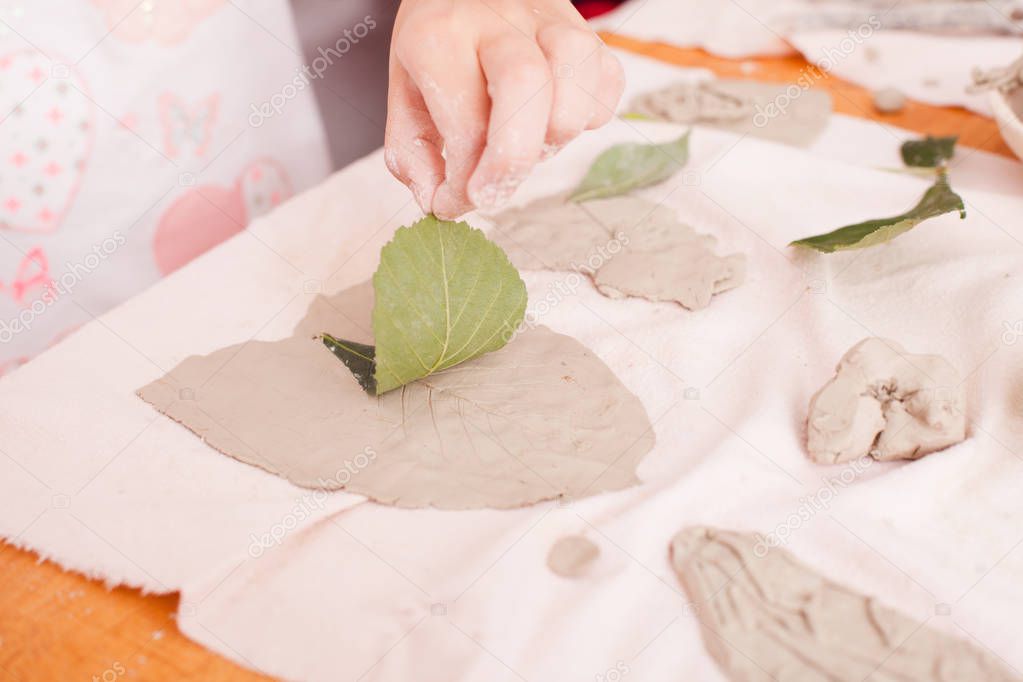 Child hands with plasticine