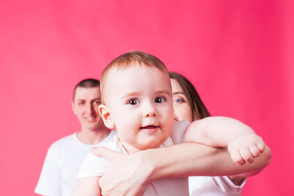 Cute baby looking at the camera, held by mother — Stock Photo, Image
