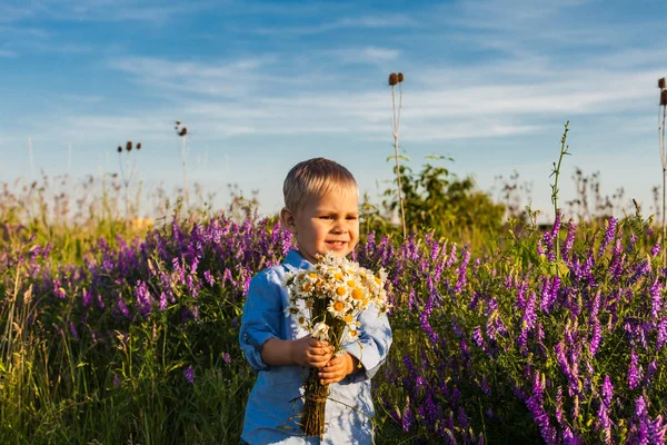 Cute boy with flowers — Stock Photo, Image