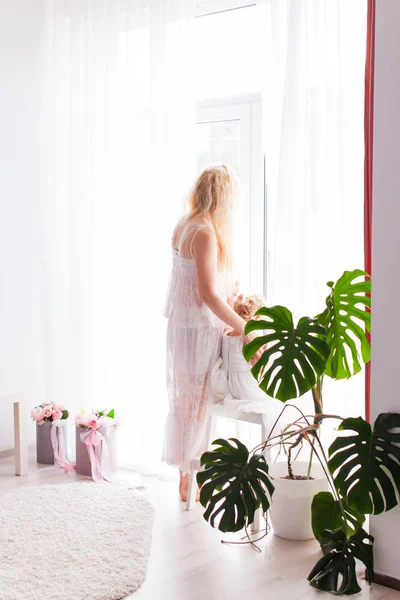 Madre y hija miren a la ventana —  Fotos de Stock