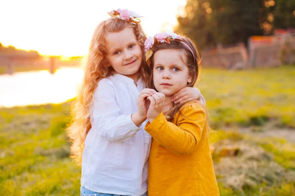 Två ganska unga flickor att göra hjärtat från händerna — Stockfoto