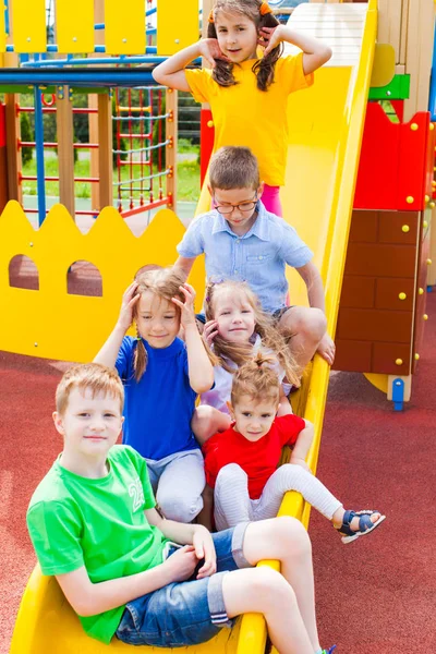 Kids traffic jam on slide in the summer outdoors — Stock Photo, Image