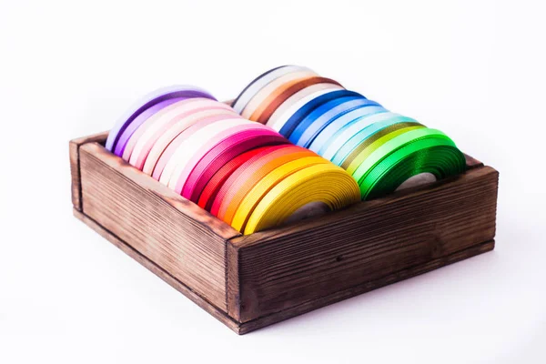 Color ribbon bobbins in the vintage box — Stock Photo, Image