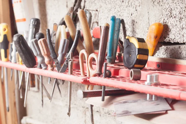 Carpenter tools fixed on the wall at workshop — Stock Photo, Image