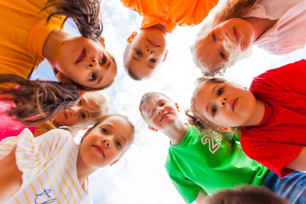 Kids standing together in circle looking at the camera — Stock Photo, Image