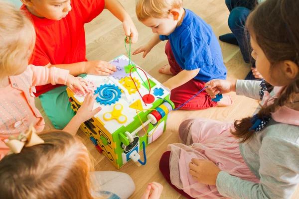 Vista cercana del juguete cubo ocupado con los niños sentados alrededor —  Fotos de Stock