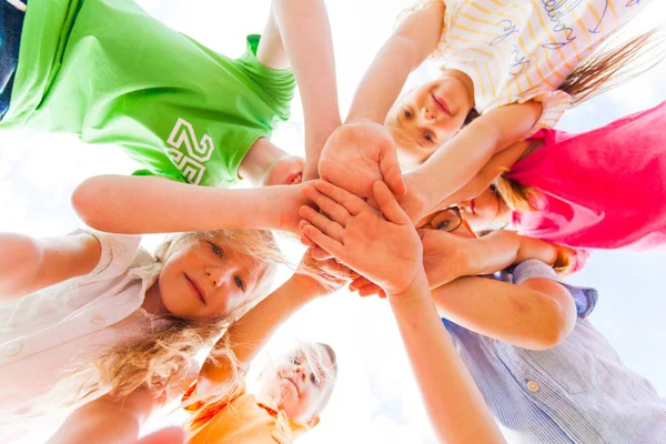 Kids hands together in circle laying one on another — Stock Photo, Image