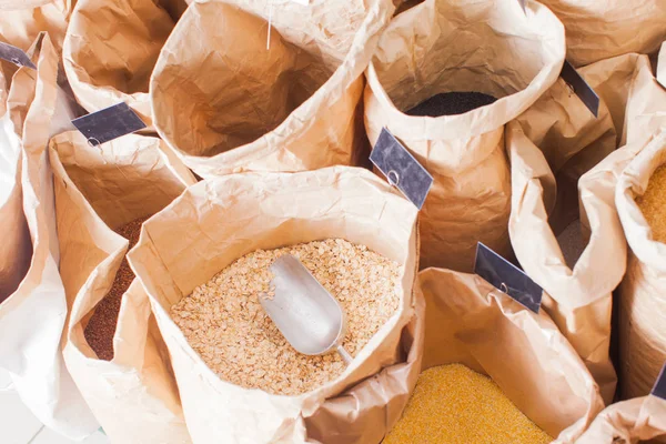 Close-up view of paper bags with cereal and groats — Stock Photo, Image