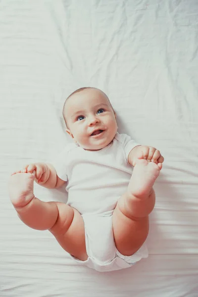 Retrato de un bebé acostado en la cama — Foto de Stock