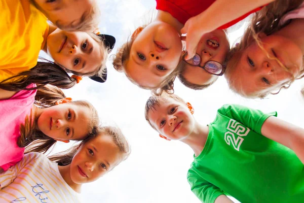 Close portrait of group of kids faces in circle Royalty Free Stock Images