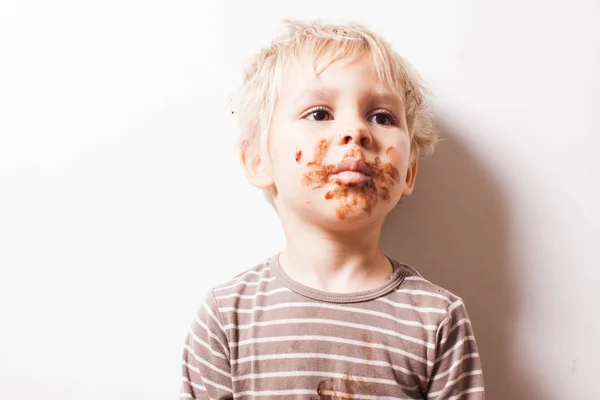 Chico comido chocolate, cara sonriente sucia divertida —  Fotos de Stock