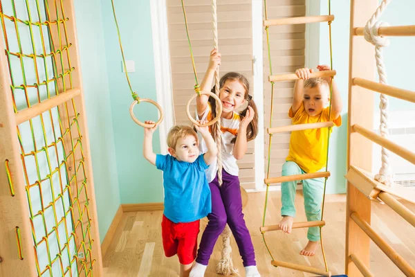 Active children excercising together at home training complex — Stock Photo, Image