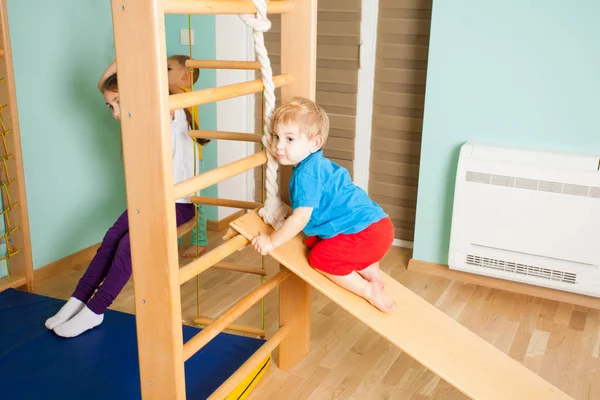 Little boy and his sister playing at home gym — Stock Photo, Image