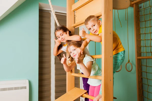 Portrait of three friends hanging on wooden bars — Stock Photo, Image