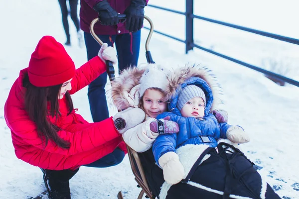 Portrait mother and of two kids in sledges — Stock Photo, Image