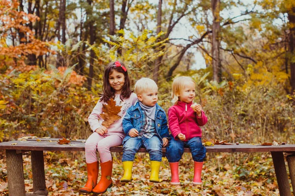 Bambini carini seduti sulla panchina dopo una lunga passeggiata — Foto Stock