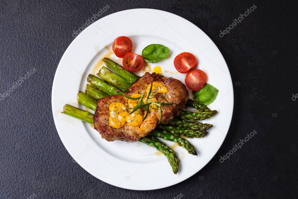Gourmet steak with green asparagus on the plate