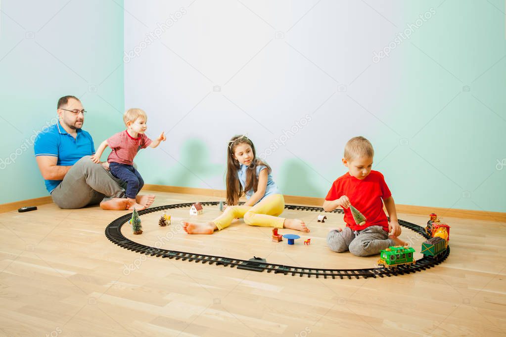 Children and their father spend time together and play