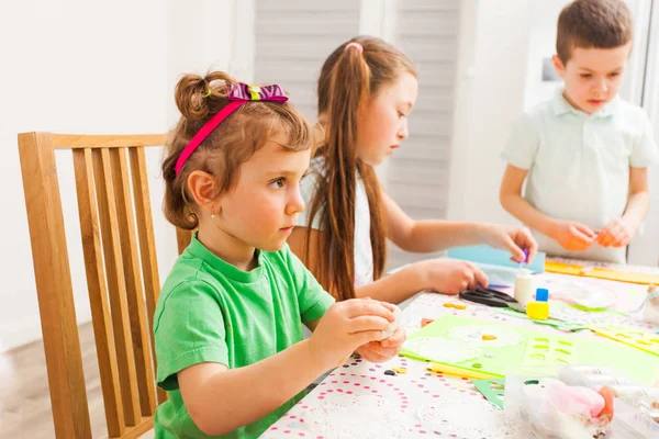 Menina faz artesanato na frente de outras crianças — Fotografia de Stock