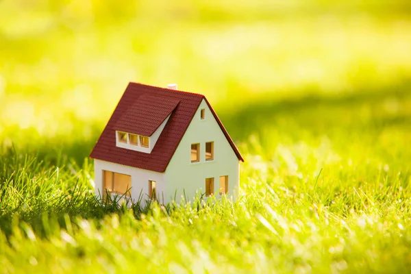 Modelo de pequena casa na grama verde — Fotografia de Stock