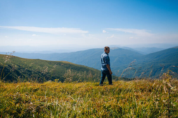 hiker on top of a mountain, beautiful world