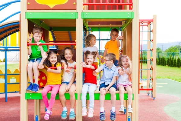 Niños descansando, sentados en escalera en el patio de recreo — Foto de Stock