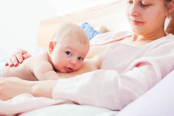 Pasgeboren en moeder in ontspannen laid back borstvoeding pose — Stockfoto