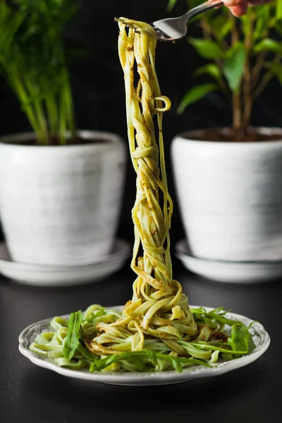 Tabakta arugula ve pesto ile makarna, siyah masa — Stok fotoğraf