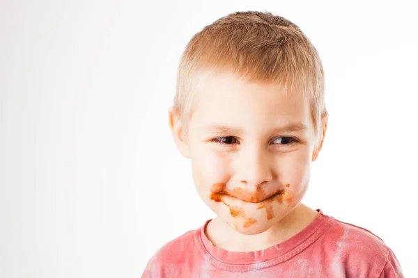 Portrait of fair-haired boy with chocolate on his face isolated on white — Stock Photo, Image