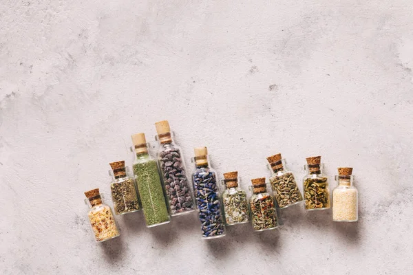 Spices in vintage bottles with copy space on gray — Stock Photo, Image