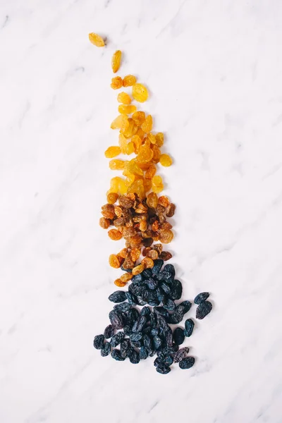 Dried raisins on a white marble background — Stock Photo, Image