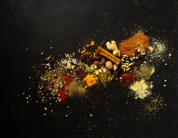 Various herbs and spices on black stone plate, art composition — ストック写真