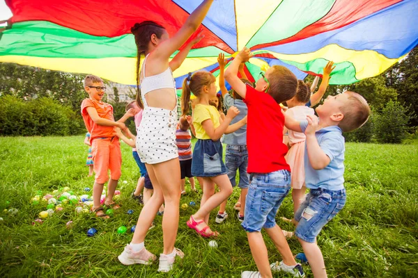 Happy kids under colorful canopy. Summer camp activities — Stock Photo, Image