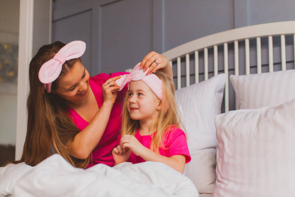 Mom and daughter are engaged in their beauty after waking up