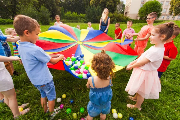 Niños alegres jugando al aire libre en la fiesta de cumpleaños —  Fotos de Stock