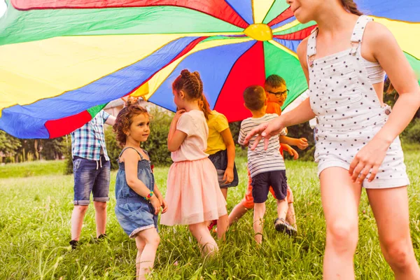 Little girl trying to join active game of older kids — Stock Photo, Image