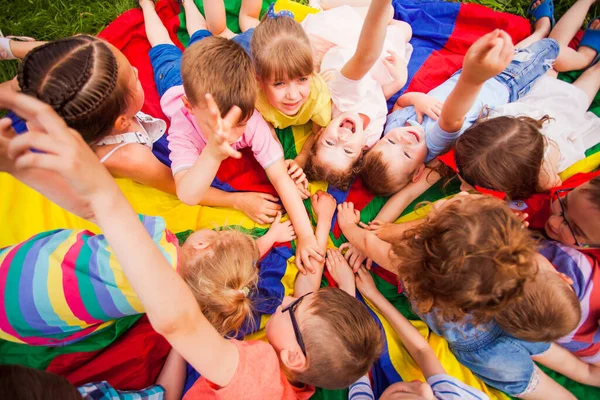 Top view bunch of kids on multicolor ground — Stock Photo, Image